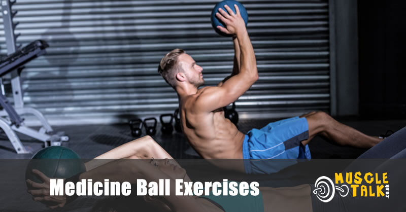 Couple doing medicine ball exercises