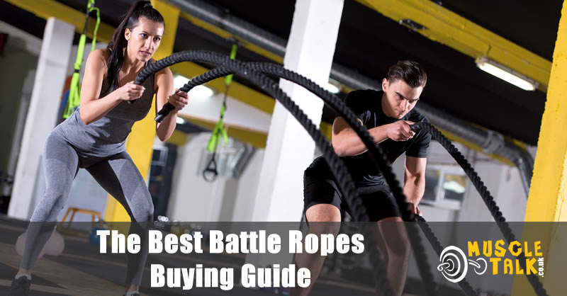 Two people training hard with battle ropes