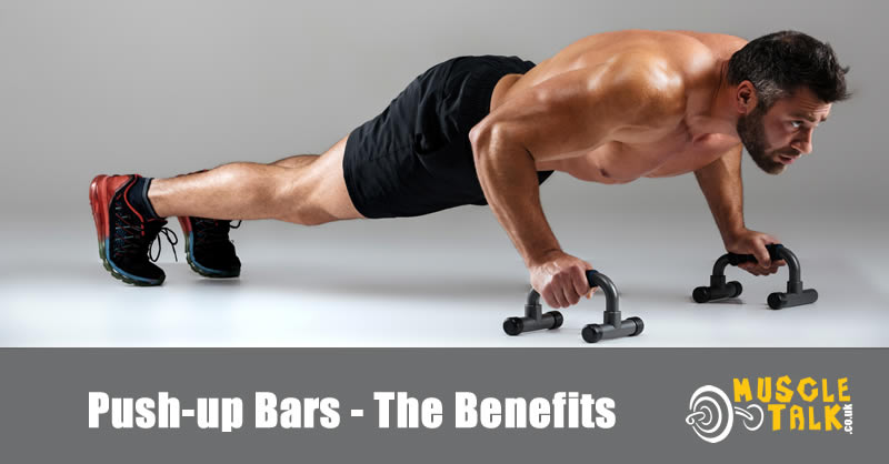 Guy exercising using push-up bars