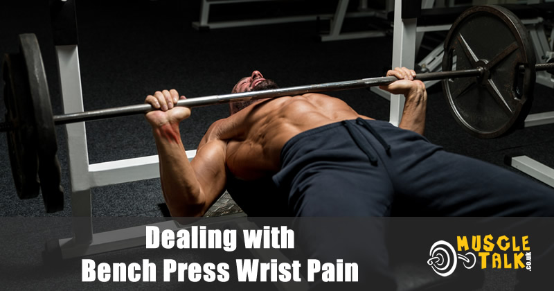 man experiencing wrist pain while bench pressing
